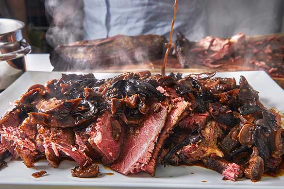 Slowly smoked beef brisket shashlik is poured with a specially prepared mushroom and onion sauce